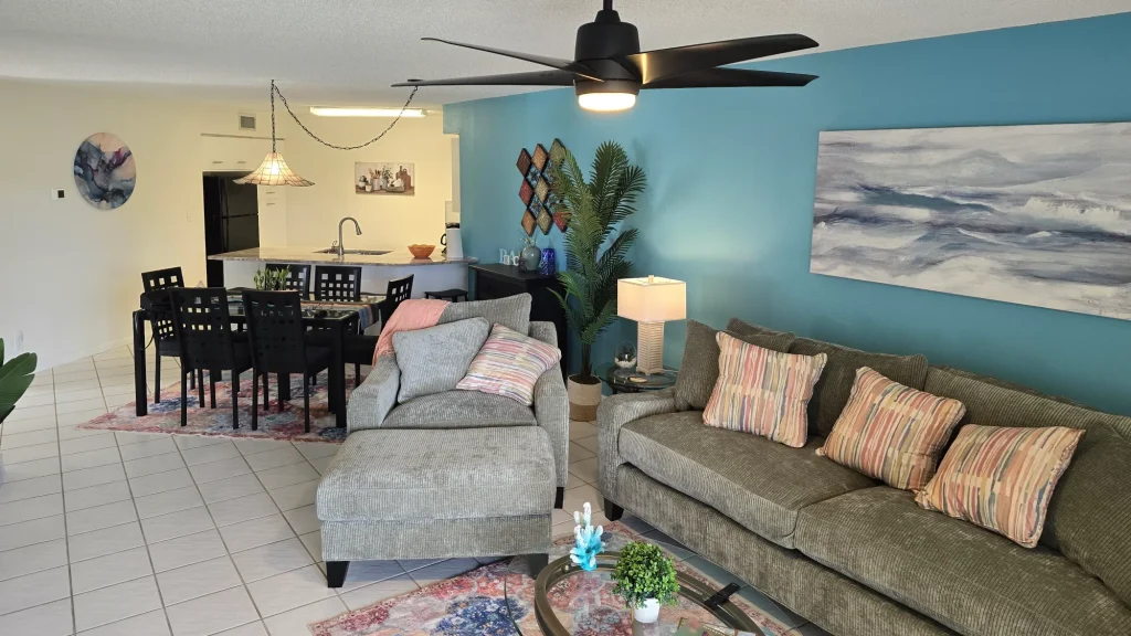 Bright coastal-themed living room with teal accent wall
