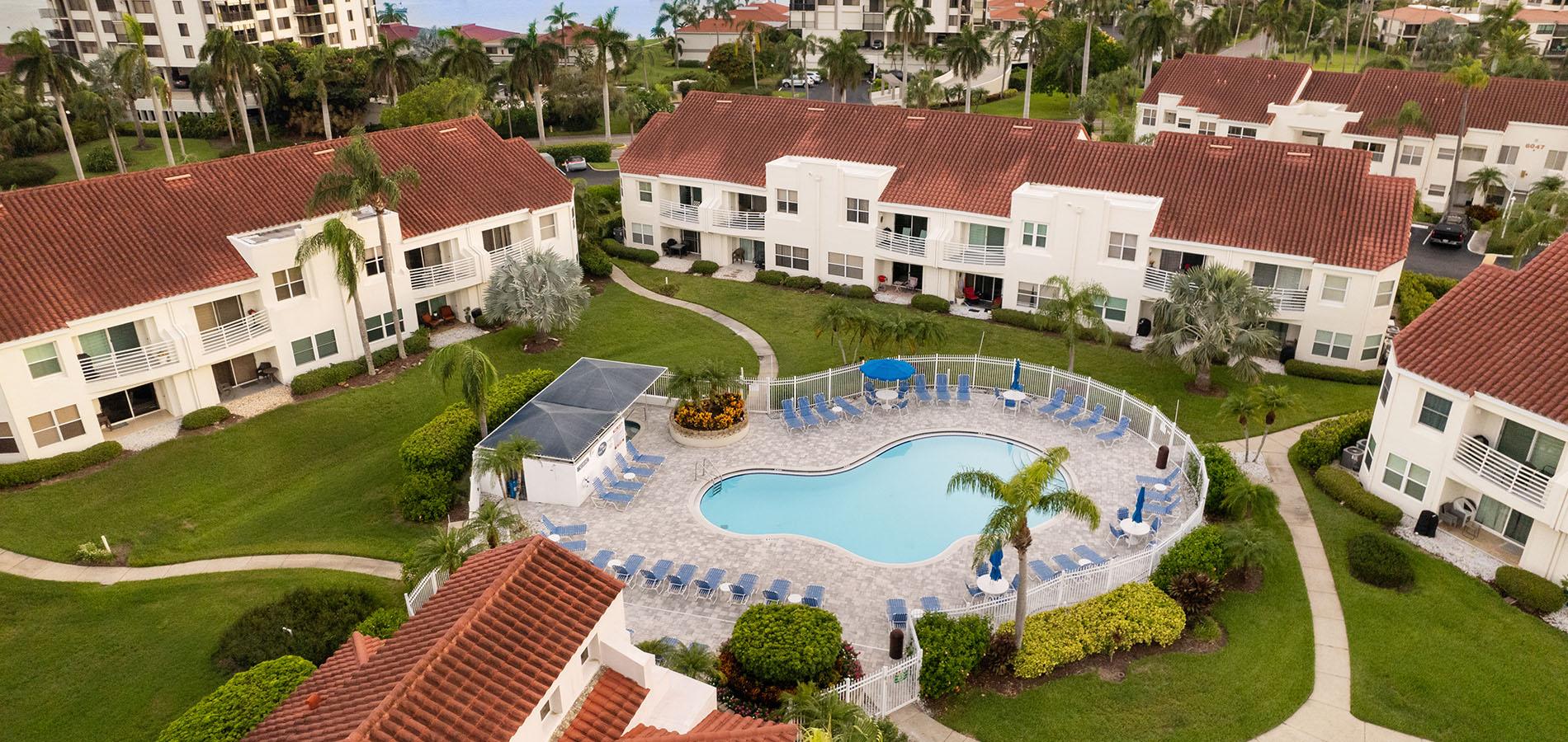 Aerial condo community pool palm resort style living