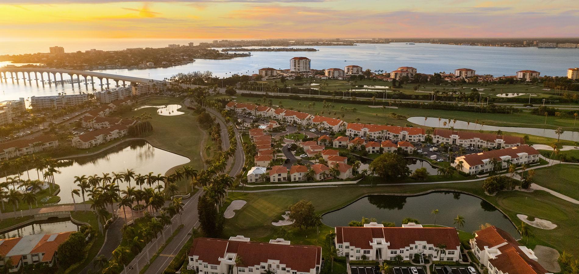 Aerial waterfront golf course community sunset coastal living