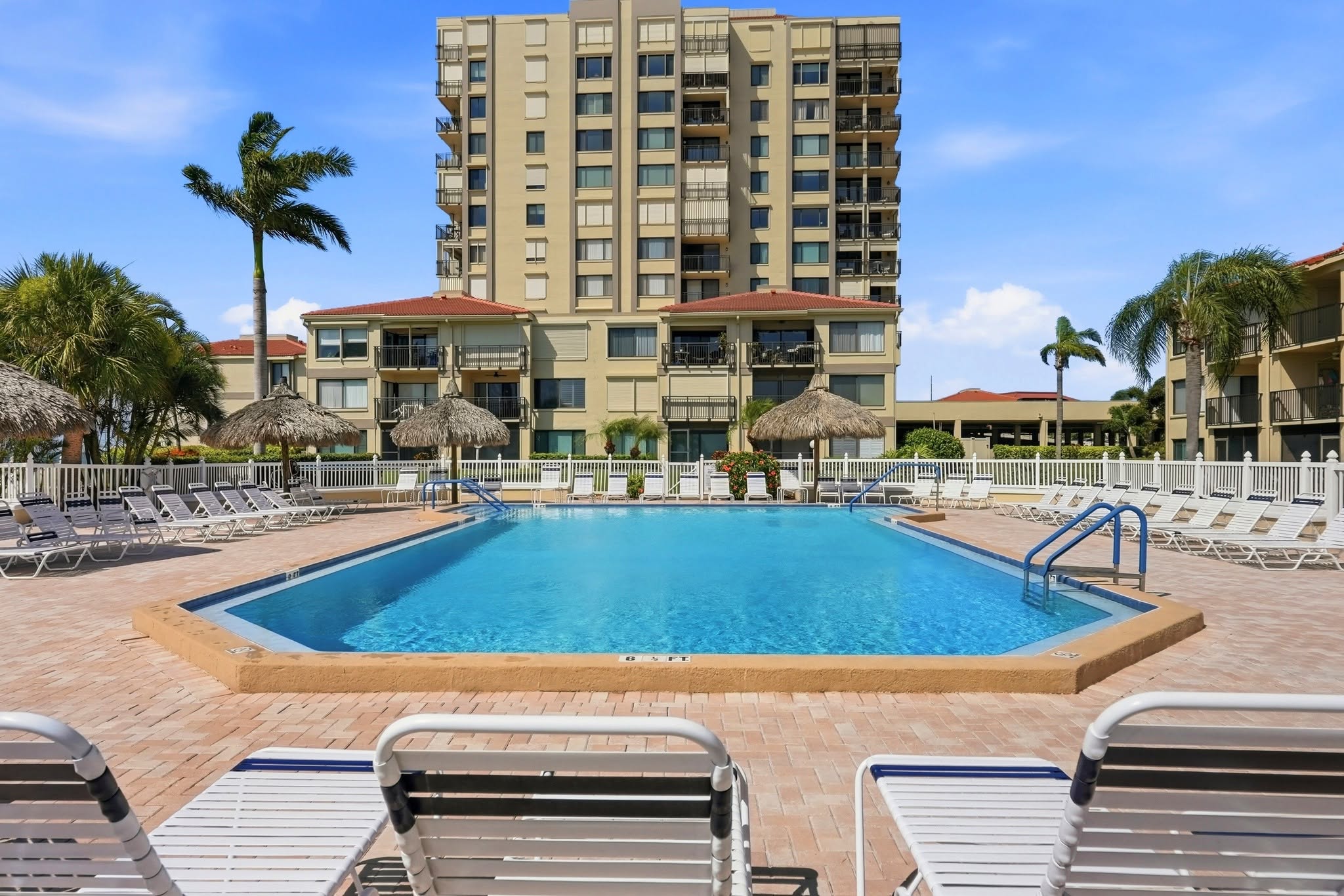 outdoor swimming pool surrounded by lounge chairs 