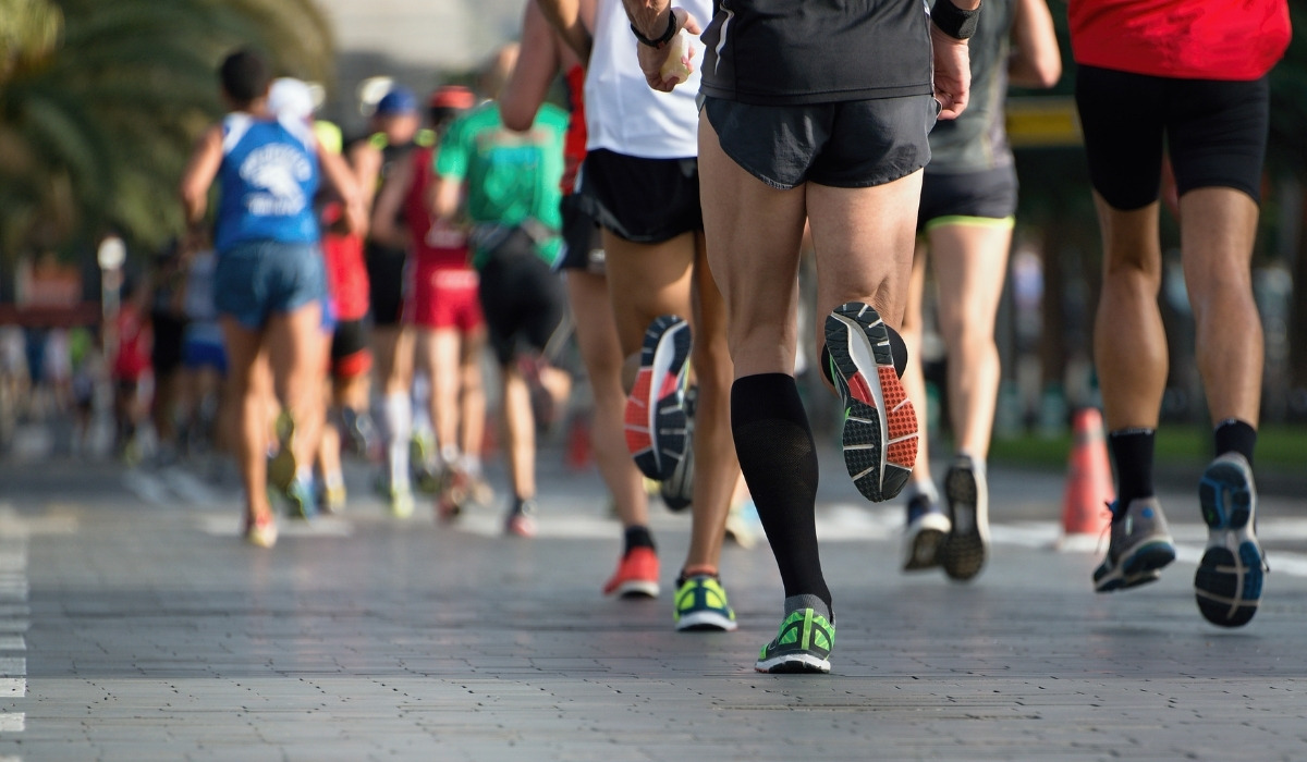 tight pack of marathon runners from behind